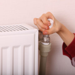 Girl thermostat on radiator