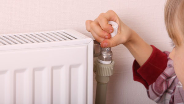 Girl thermostat on radiator