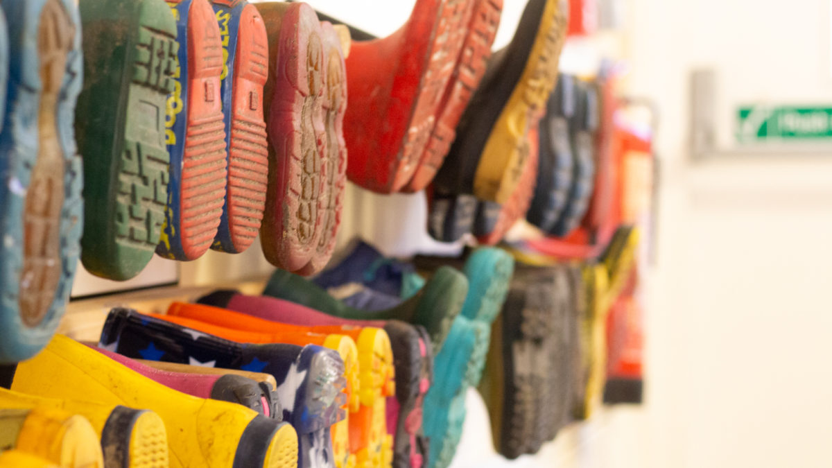 A row of kids' wellies in a nursery