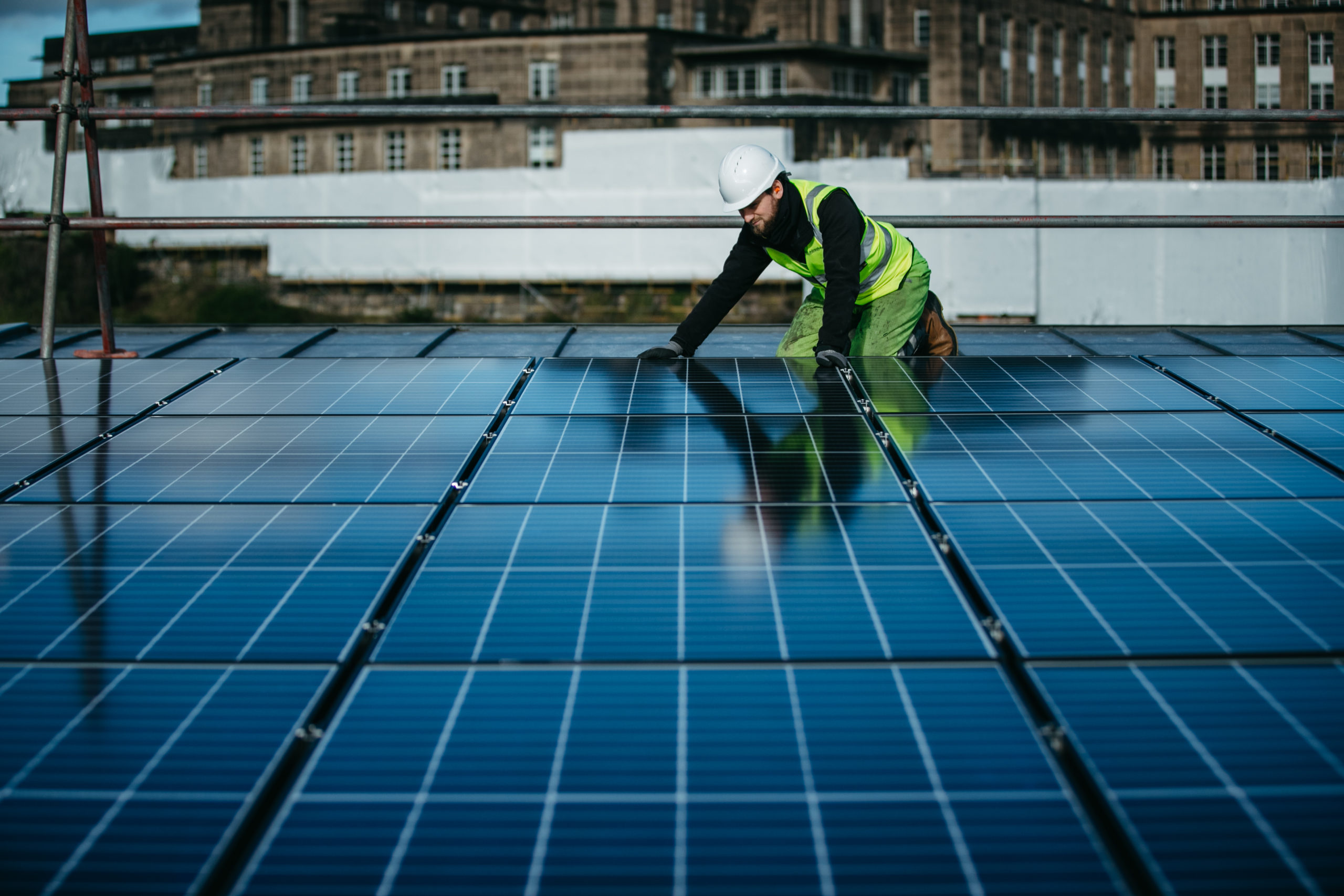 FREE TO USE PICS. 26/2/2021. Pics of the roof of Edinburgh City Council's offices, Waverley Court being fitted with Solar panels, as part of Edinburgh Community Solar Co-operative's share issue. Pic shows a workman fitting the panels.