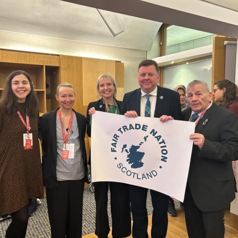 Colin Smyth MSP and representatives from Scottish Fair Trade holding a banner that says Fair Trade Nation ScotlandScotland