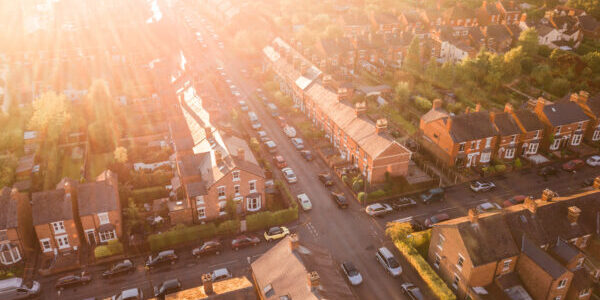 Sun setting over a traditional British neighbourhood. Lens flare and warm colours to give a homely effect.